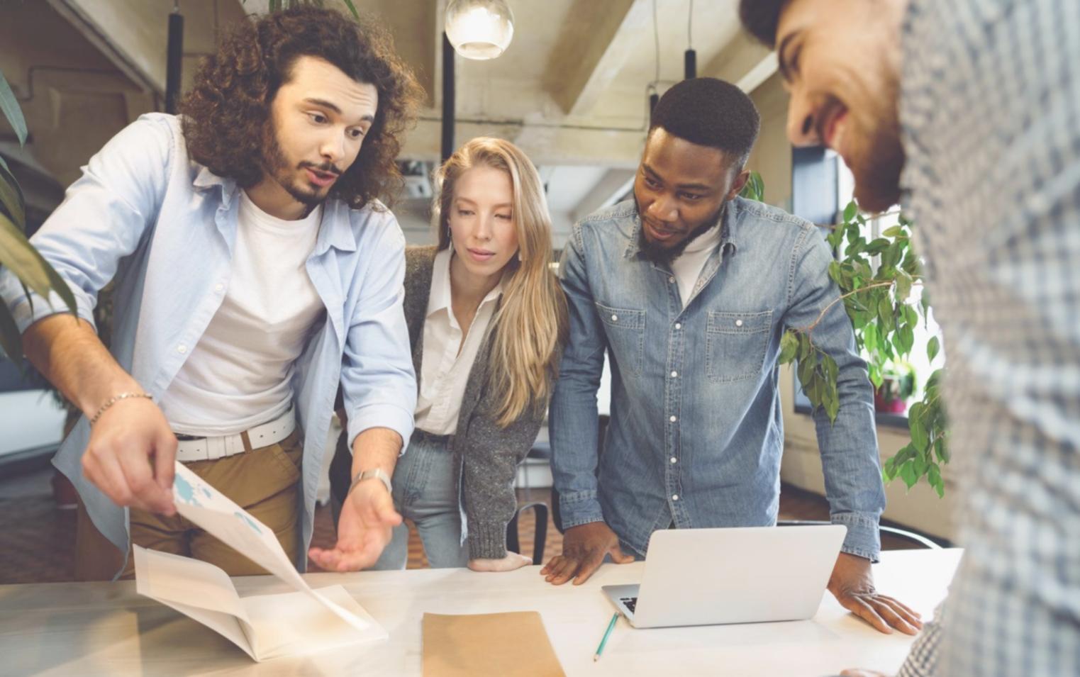 Person reviewing financial documents with calculator and laptop